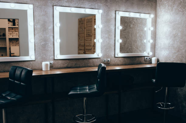 Room with makeup mirror lights Interior of a beauty salon. Room with makeup mirror lights and black chair backstage mirror stock pictures, royalty-free photos & images