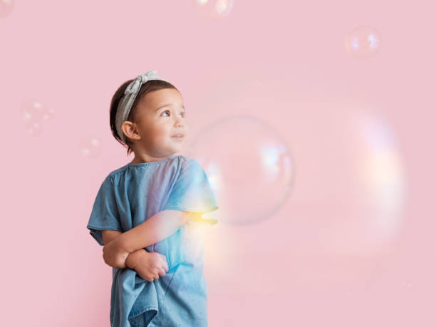 istock Infant girl scared of bubbles 1158041603