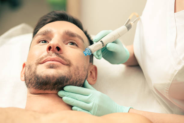 istock Face of the man during the skin procedure with modern tool 1158043183