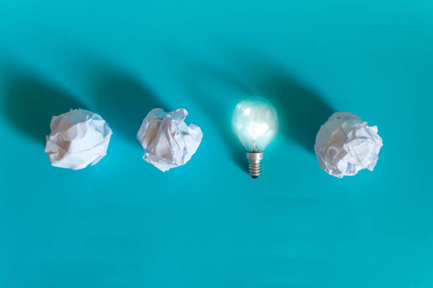 istock Concept of bright idea with paper and light bulbs 1158045005