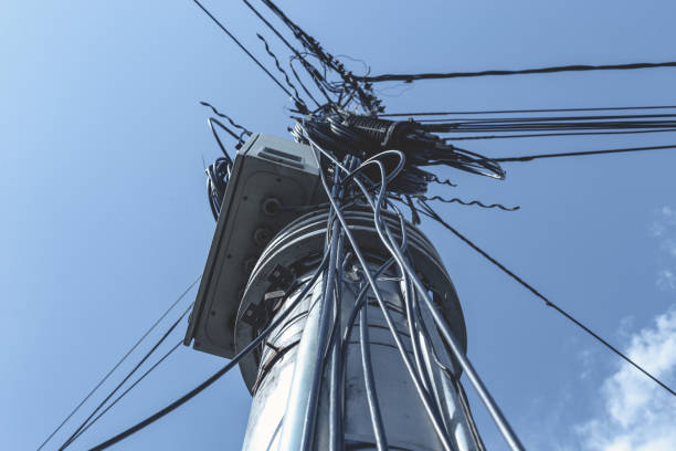 istock Messy tangled black wires on cement pillar 1158046664