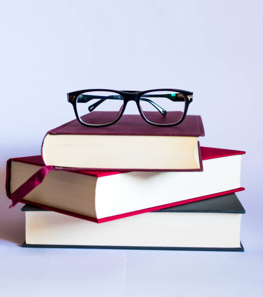 istock Image with books and glasses on white background 1158047305
