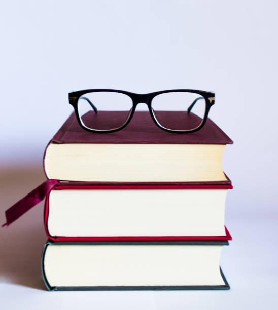 istock Image with books and glasses on white background 1158047336