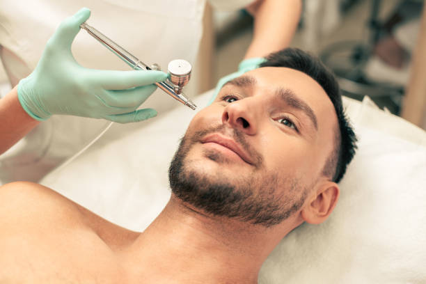 istock Oxygen spray treatment procedure of the young man 1158047966