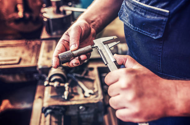istock Operator working on the lathe machine and measuring the shaped material, close up photo. Concept of industry 1158048074