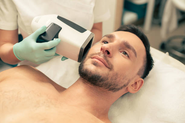 istock Calm man with skin analysis camera near his cheek 1158048514