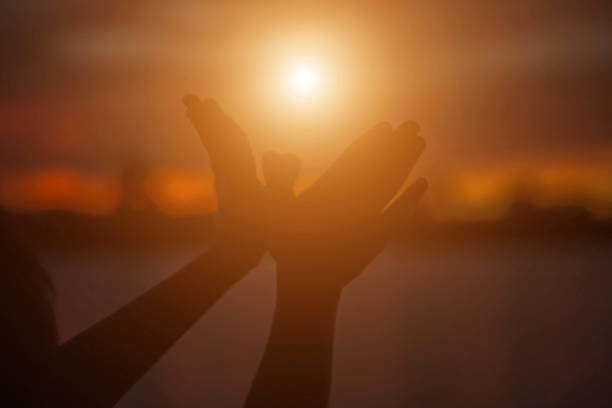 istock hands forming a heart shape with sunset silhouette 1158049871
