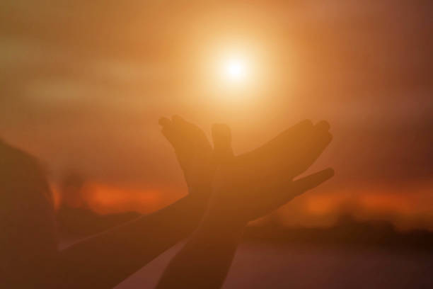 istock hands forming a heart shape with sunset silhouette 1158049882