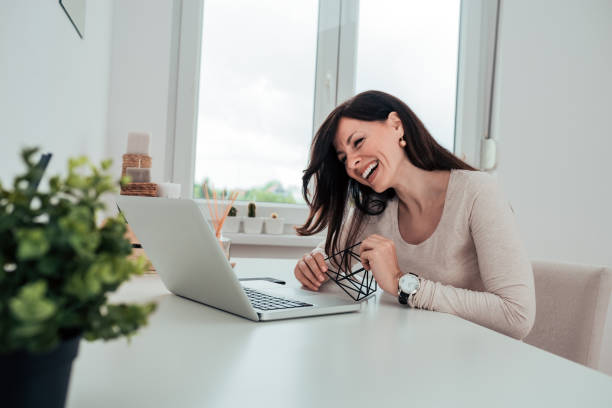 portrait of a beautiful woman laughing while sitting at home office. - 2271 imagens e fotografias de stock
