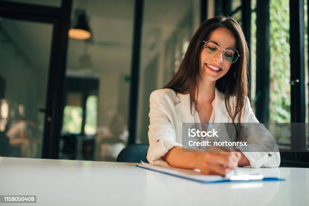 Motivated Young Woman Hand Filling Application Form Stock Photo - Download Image Now