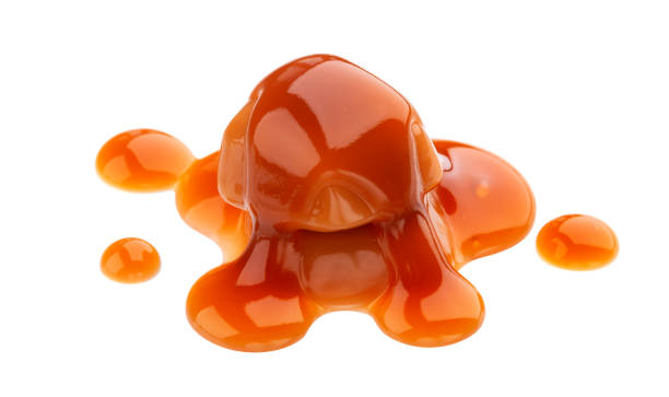 istock Caramel candies and caramel sauce isolated on white background 1158051568