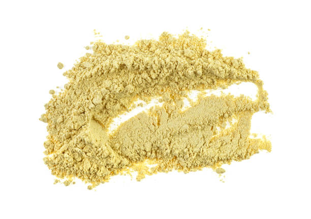 istock Heap of dried ginger powder isolated on white background 1158053677