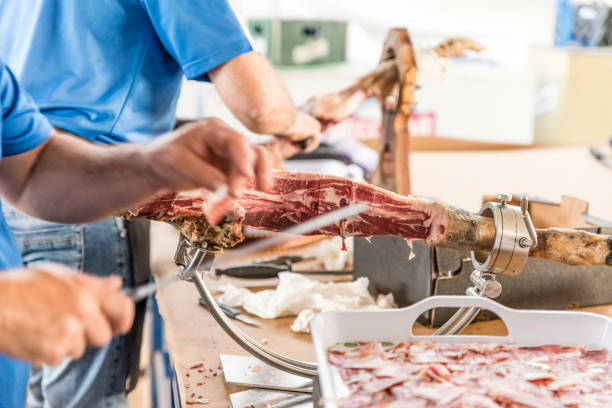istock hands of man cutting ham 1158053926
