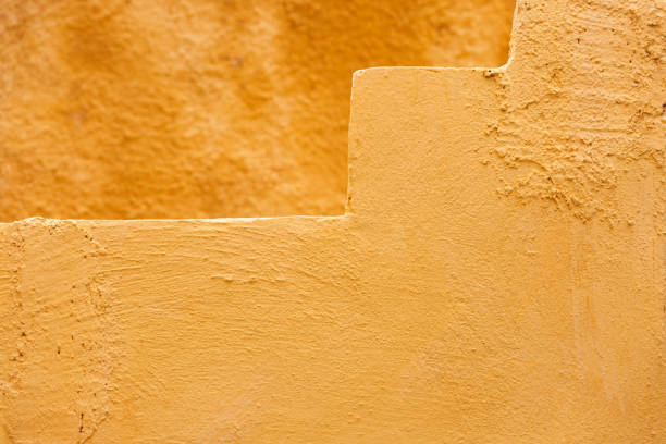 Texture Of Ocher Yellow Orange Colored Old Stone Wall and  Steps, close up