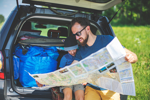 Father and son looking at map