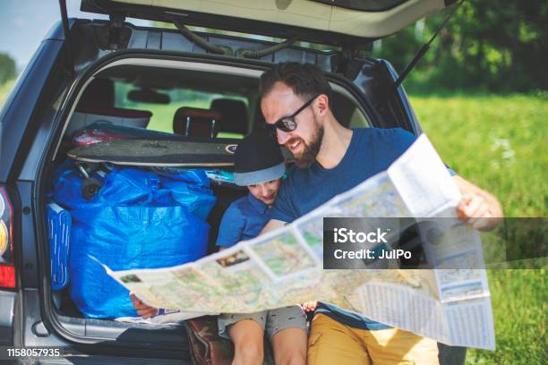 Father And Son Looking At Map Stock Photo - Download Image Now - Road Trip, Map, Car