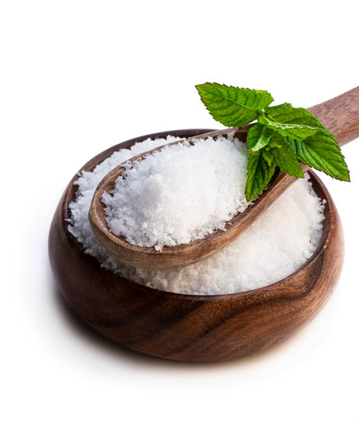 istock Wooden spoon with sea salt isolated on white 1158060220