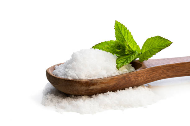 istock Wooden spoon with sea salt isolated on white 1158060401