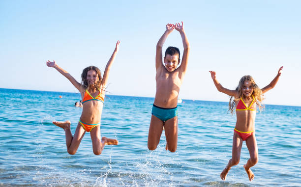 istock Children jumping at the beach 1158060436