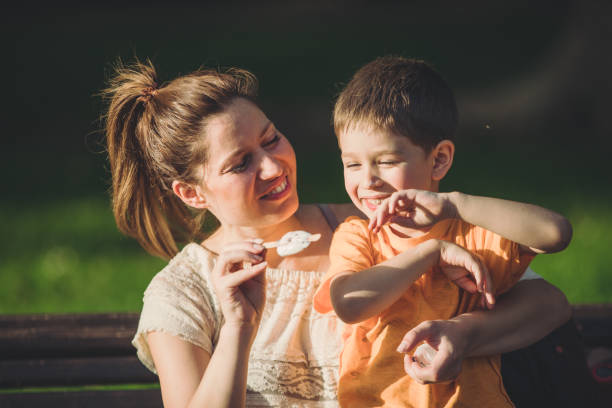 istock Mother and her son having fun with ice cream and hugging 1158061560
