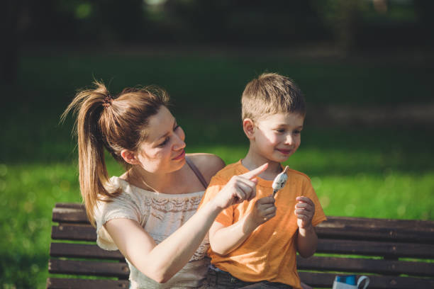 istock Mother and her son having fun with ice cream and hugging 1158061561