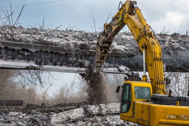 istock Professional demolition of reinforced concrete structures using industrial hydraulic hammer. Rods of metal fittings. Wreckage and crumbles of concrete. 1158061881