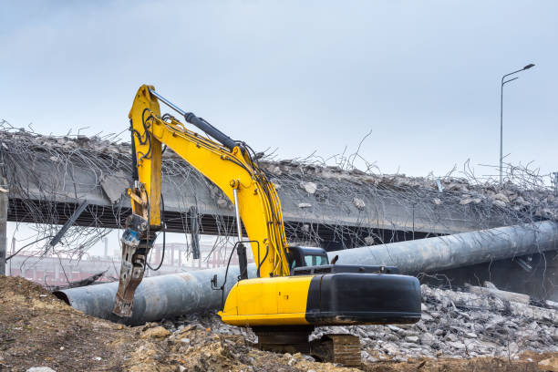 istock Professional demolition of reinforced concrete structures using industrial hydraulic hammer. Rods of metal fittings. Wreckage and crumbles of concrete. 1158061883
