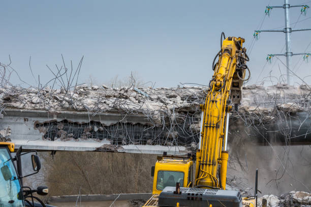 istock Professional demolition of reinforced concrete structures using industrial hydraulic hammer. Rods of metal fittings. Wreckage and crumbles of concrete. 1158061887