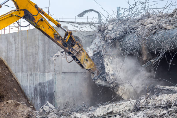 istock Professional demolition of reinforced concrete structures using industrial hydraulic hammer. Rods of metal fittings. Wreckage and crumbles of concrete. 1158061888
