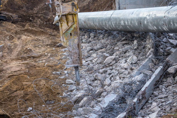 istock Professional demolition of reinforced concrete structures using industrial hydraulic hammer. Rods of metal fittings. Wreckage and crumbles of concrete. 1158061889