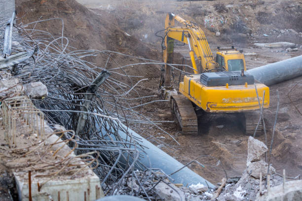 istock Professional demolition of reinforced concrete structures using industrial hydraulic hammer. Rods of metal fittings. Wreckage and crumbles of concrete. 1158061904