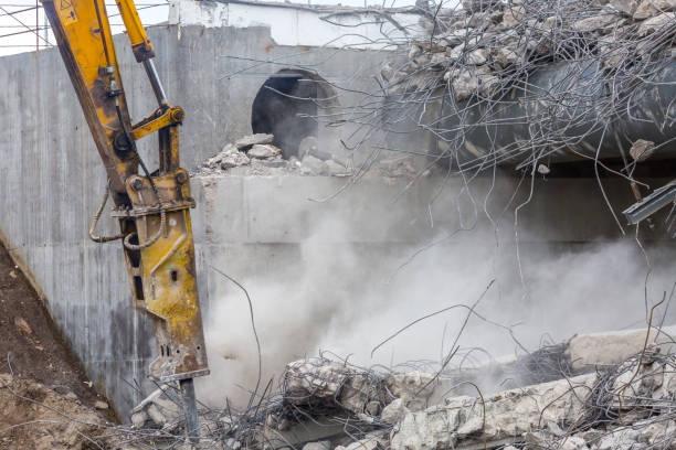 istock Professional demolition of reinforced concrete structures using industrial hydraulic hammer. Rods of metal fittings. Wreckage and crumbles of concrete. 1158061905