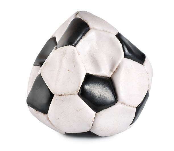Deflated soccer ball stock photo