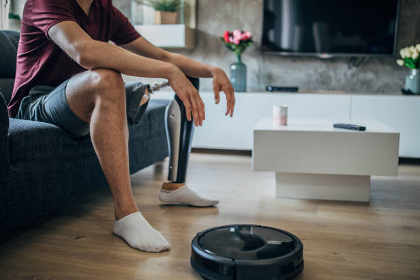 istock Man with prosthetic leg sitting on sofa 1158065870