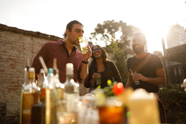 istock Friends having premium cocktails in a rooftop at sunset 1158067000
