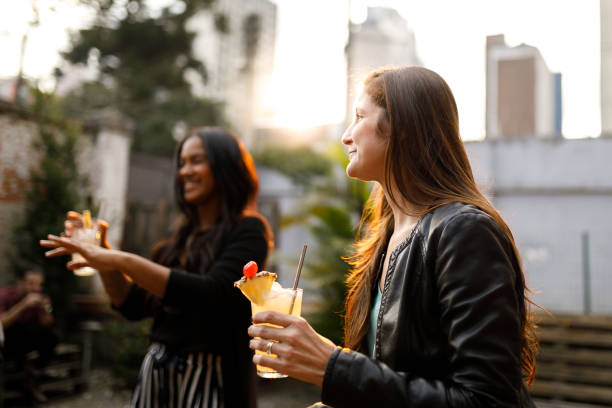 istock Friends having premium cocktails in a rooftop at sunset 1158067100