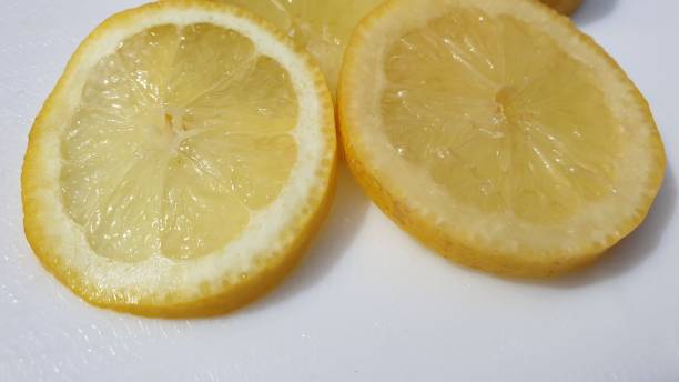 istock Slice on lemon in close-up on white background 1158068057