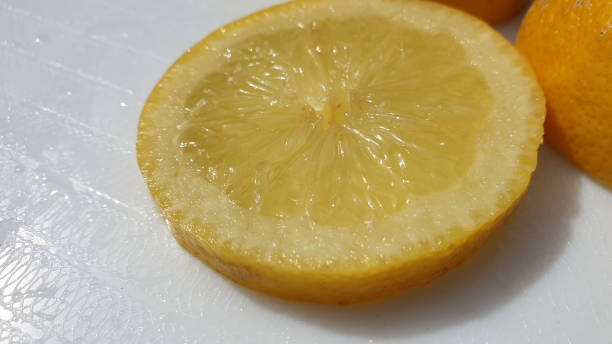 istock Slice on lemon in close-up on white background 1158068068