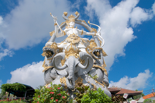Ubud, Bali, Indonesia - 5th May 2019 : Low angle view on the majestic Arjuna Statue located at the roundabout in Ubud, Bali - Indonesia