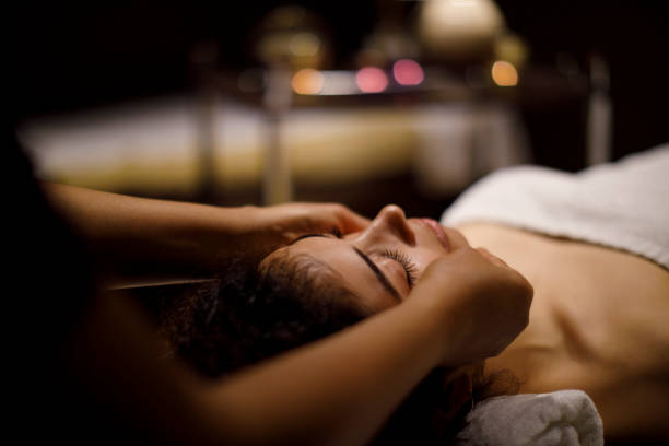 istock Woman enjoying head massage in spa center 1158069573