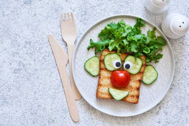 istock Cheerful clown. Sandwich for children for breakfast. View from above. 1158070267