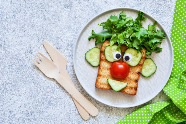 istock Cheerful clown. Sandwich for children for breakfast. View from above. 1158070274