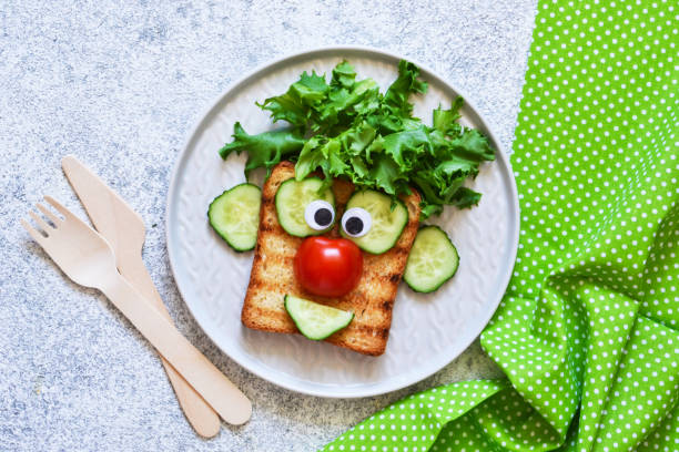 istock Cheerful clown. Sandwich for children for breakfast. View from above. 1158070301