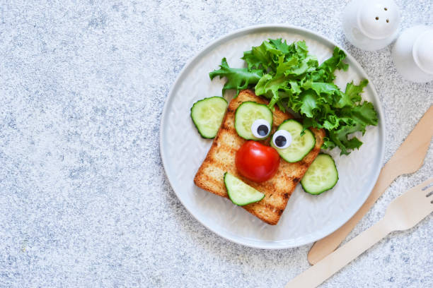 istock Cheerful clown. Sandwich for children for breakfast. View from above. 1158070319