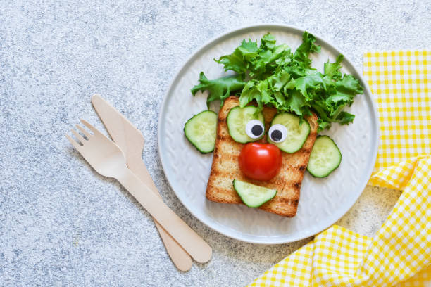 istock Cheerful clown. Sandwich for children for breakfast. View from above. 1158070334