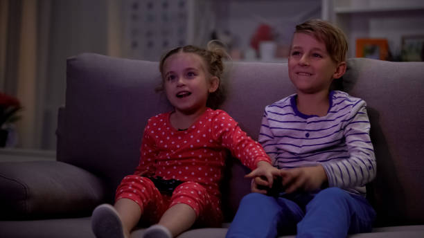 istock Small sister taking brothers joystick, loosing video game, having fun together 1158073211