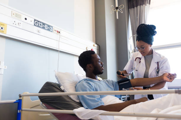 istock Young doctor examining patient's blood pressure 1158074949