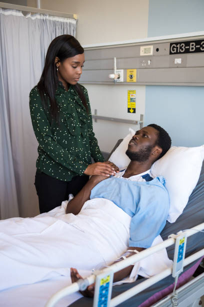 istock Woman consoling her ill husband lying on bed 1158074960