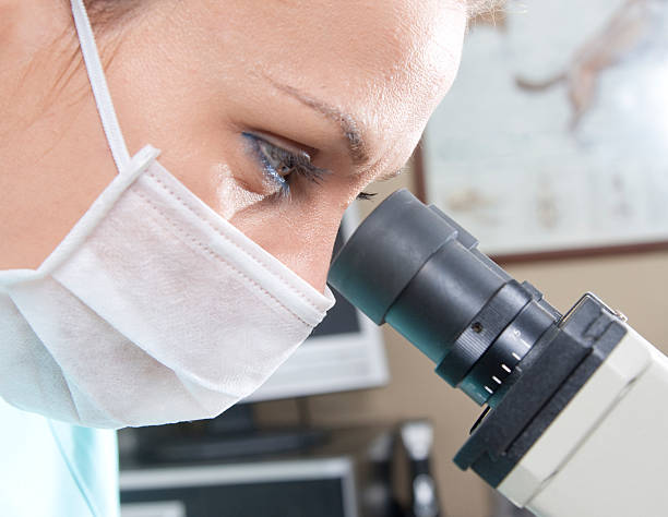 Female Scientist Working with microscope stock photo
