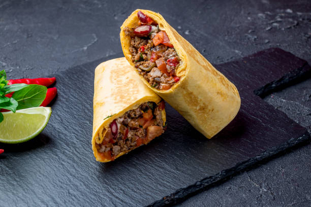 Mexican burrito with meat Mexican burrito with meat on black burrito photos stock pictures, royalty-free photos & images